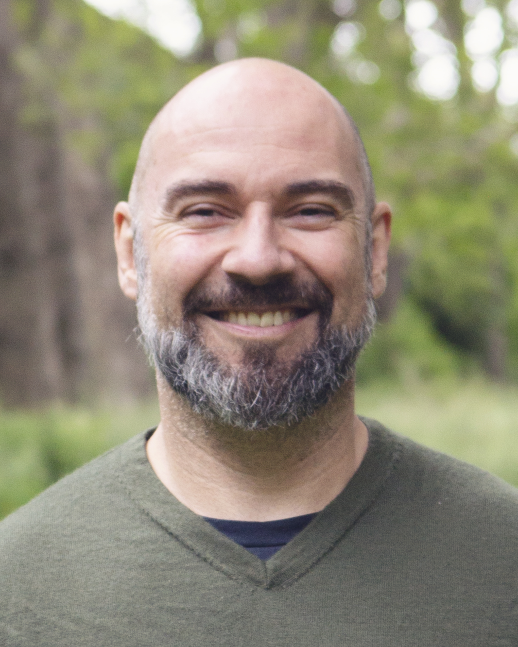 Profile photo of ben gardiner with a green forest background 