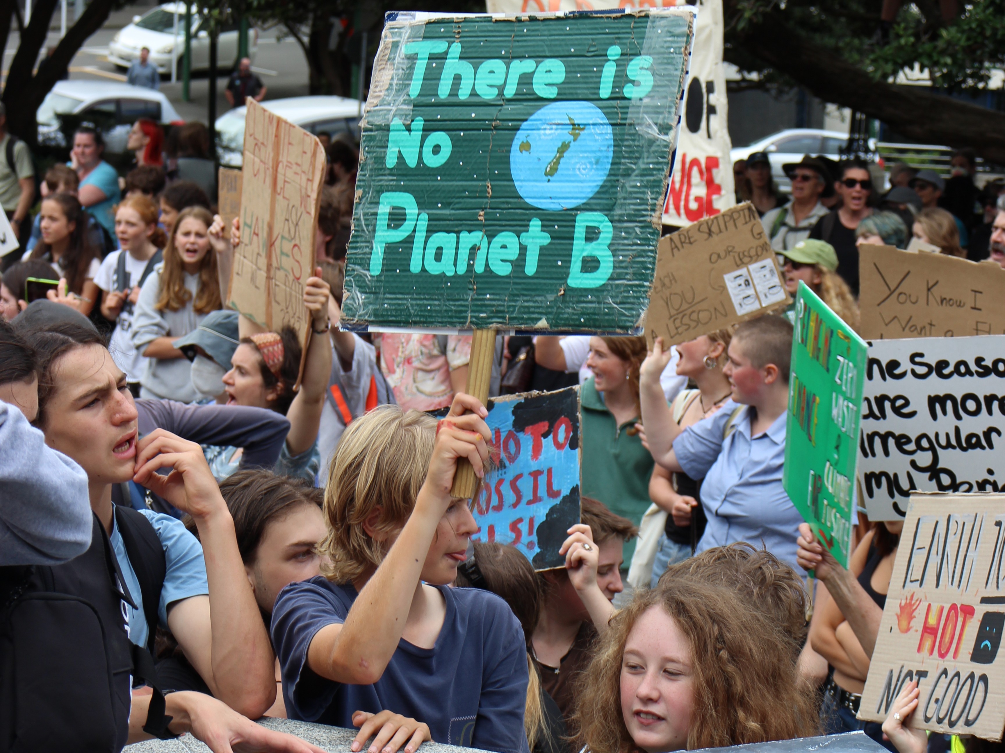 Children at the school strikes for climate protest holding signs about the impotance of addressing climate change, including "there is no planet B"