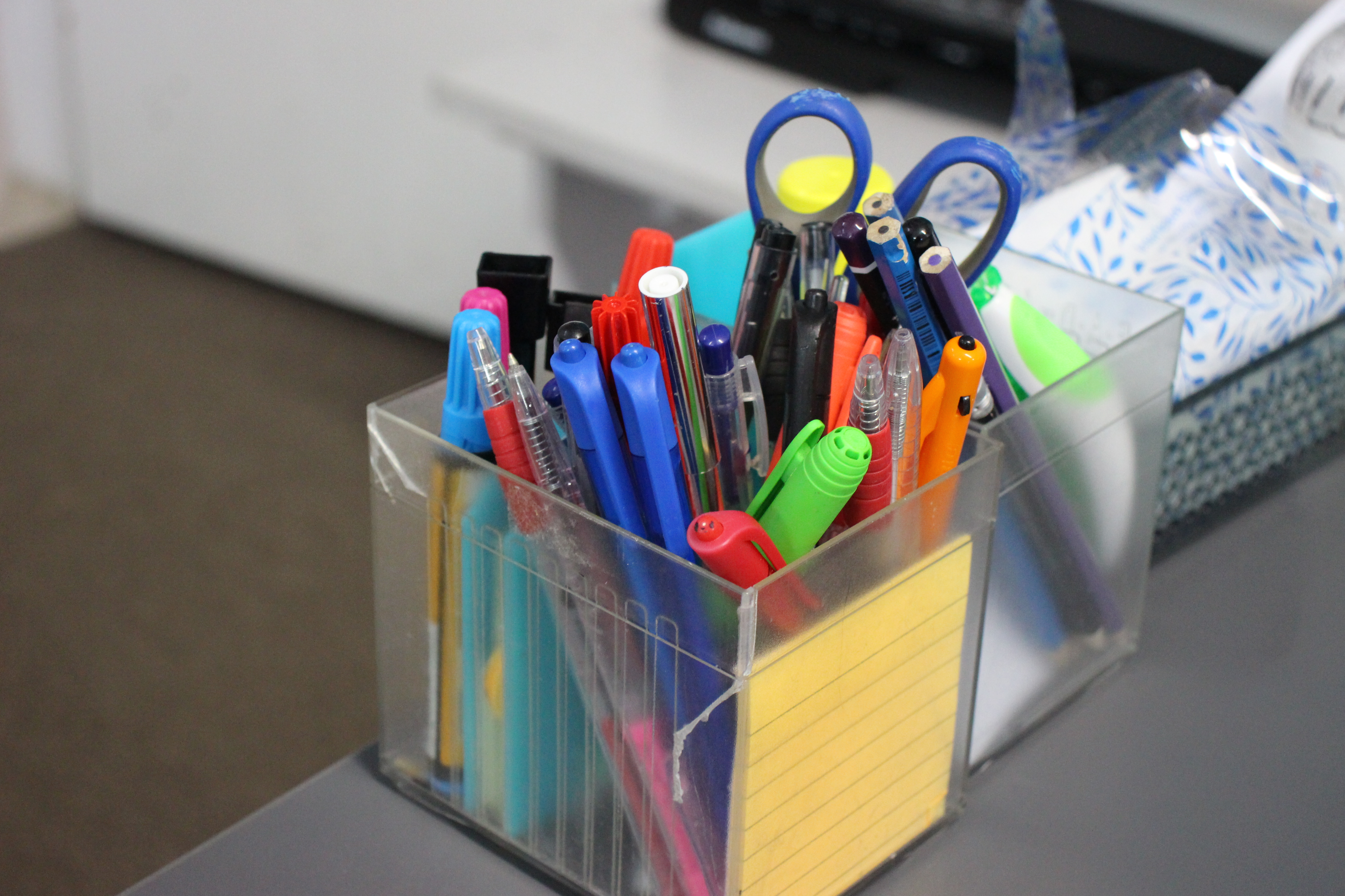 close up of pens in a classroom also some scissors