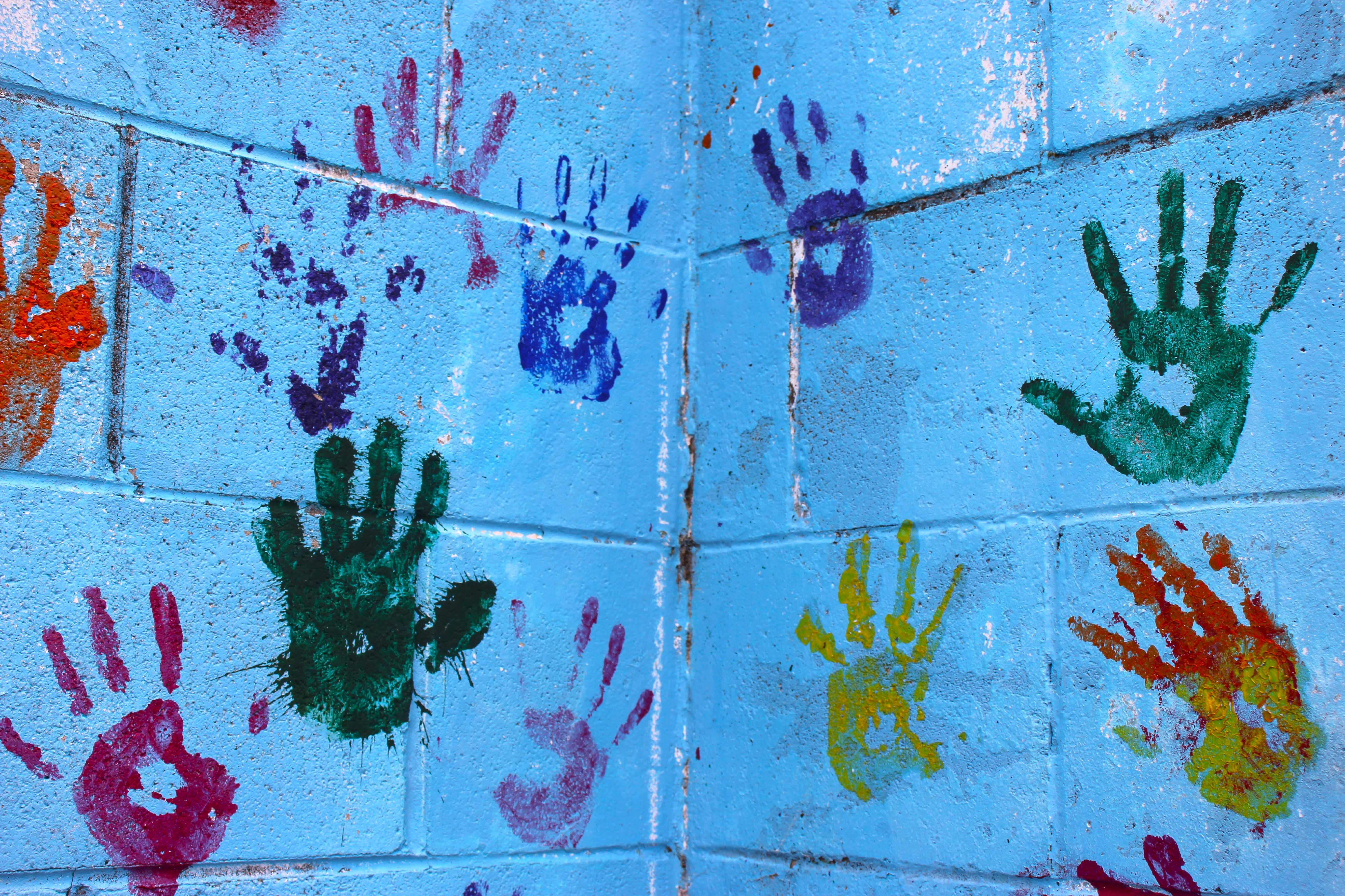 painted hands on a blue wall