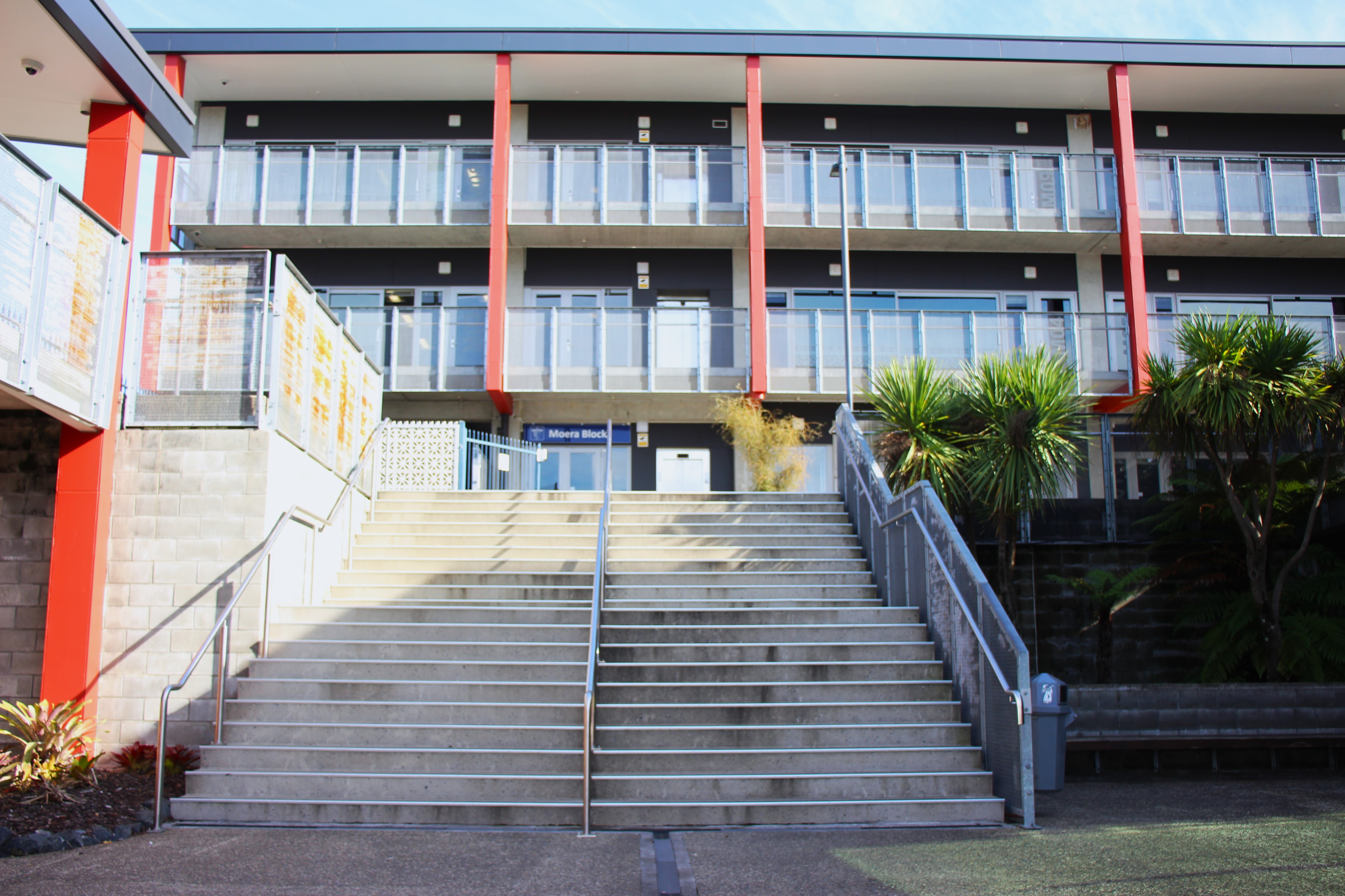 Exterior of a secondary school building with steps in front 