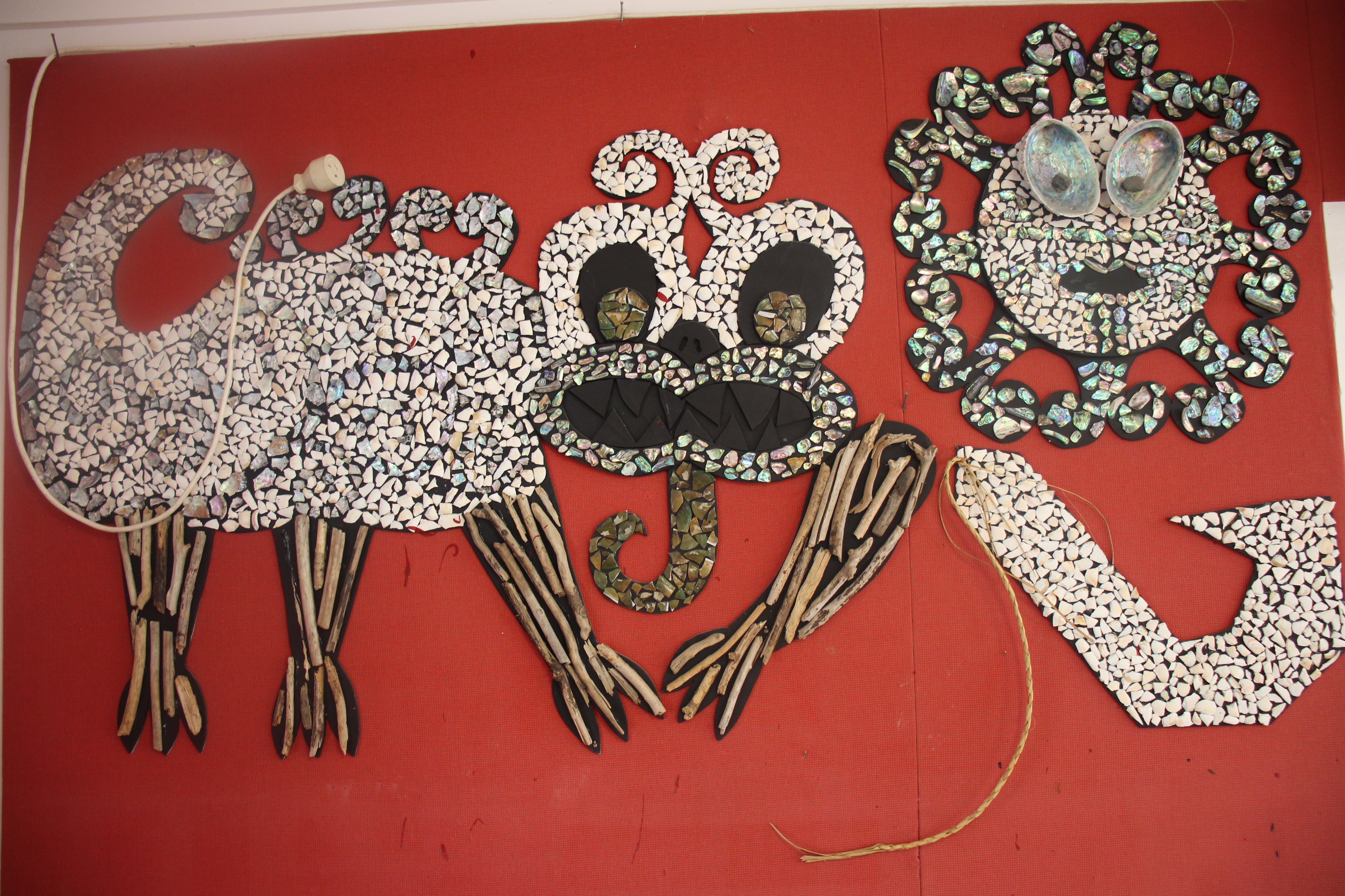 Taniwha art from a kindergarten on red background