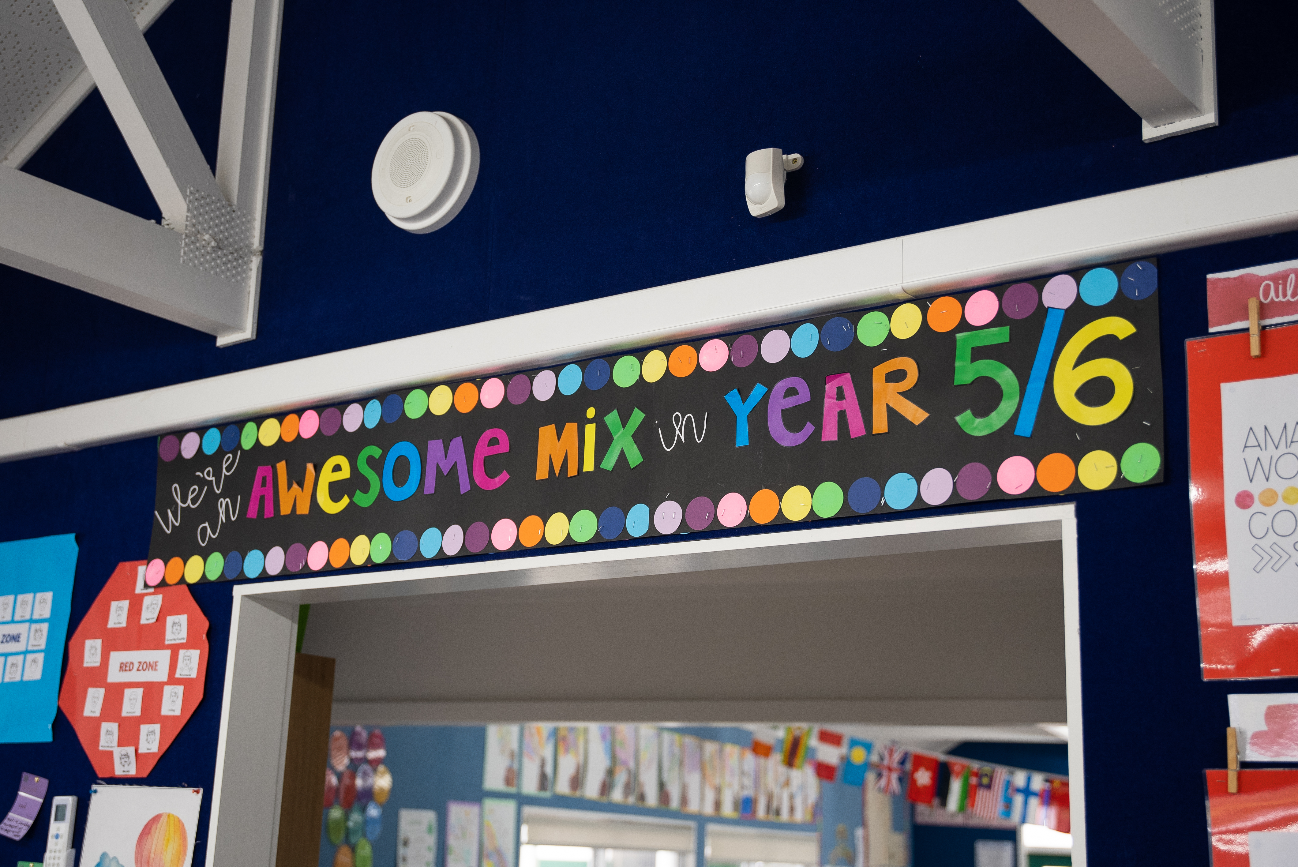 A primary school classroom wall with a colourful sign saying "We are an awesome mix in Year 5/6"