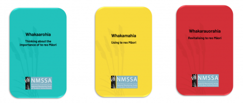 three cards from the aronuitia te reo card deck, one green one yellow one red, each with words in reo māori and english