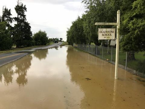 Flood water is pooled around the sign for Gladstone Primary School