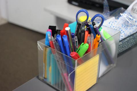 close up of pens in a classroom also some scissors