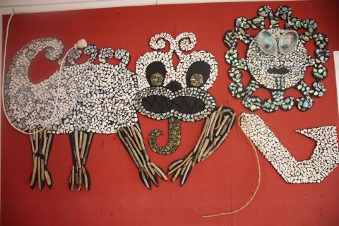 Taniwha art from a kindergarten on red background