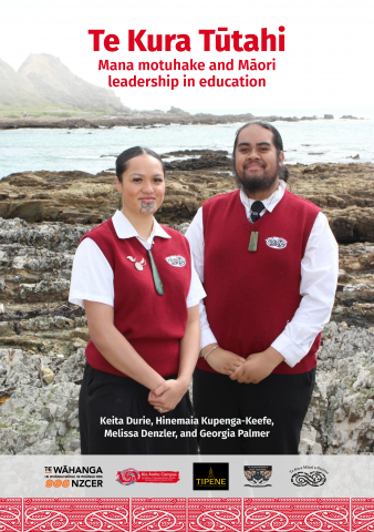Report cover with two students wearing red, white and black uniform against a background of rocks and the ocean