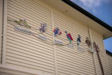 School exterior with images of birds and words representing school values 